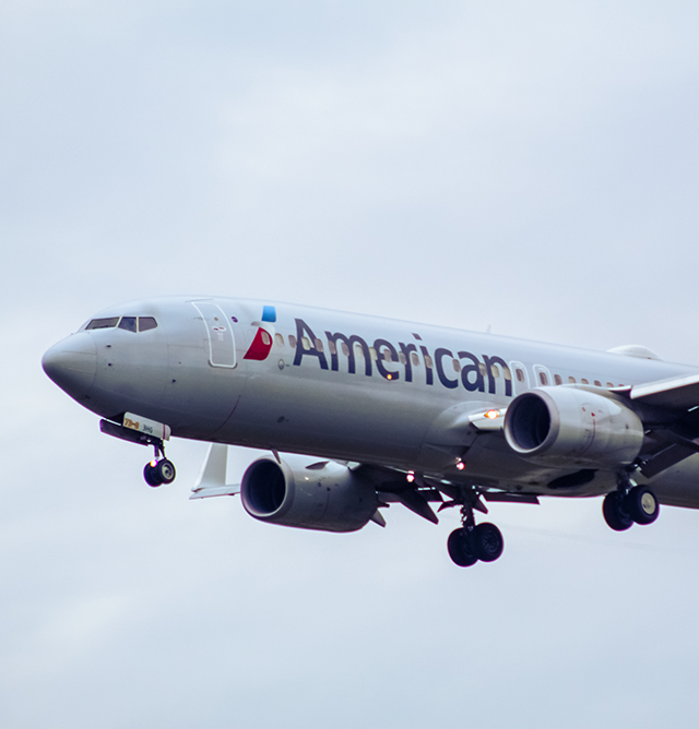 an american alines jet flying through the air